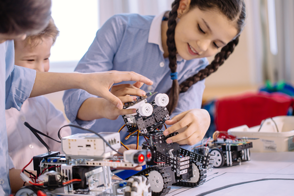 children playing with toy robots